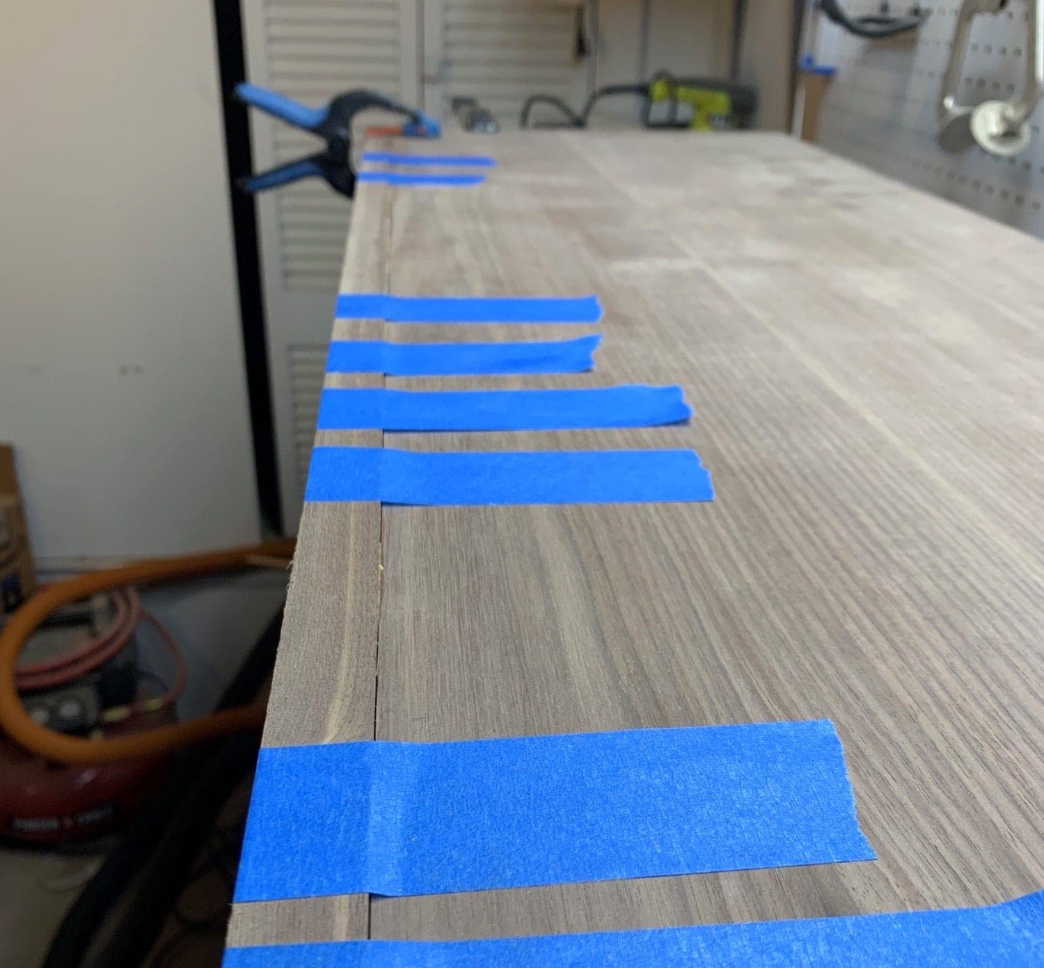 the top piece with the edging taped and clamped to it