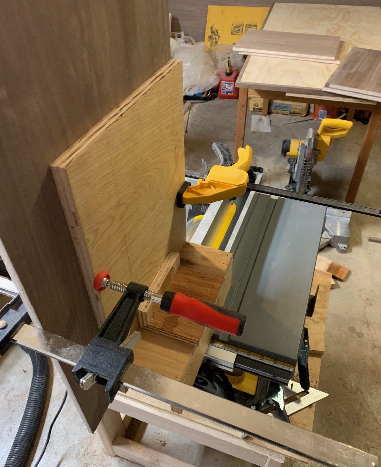 jig on the table saw with the bottom piece clamped to it