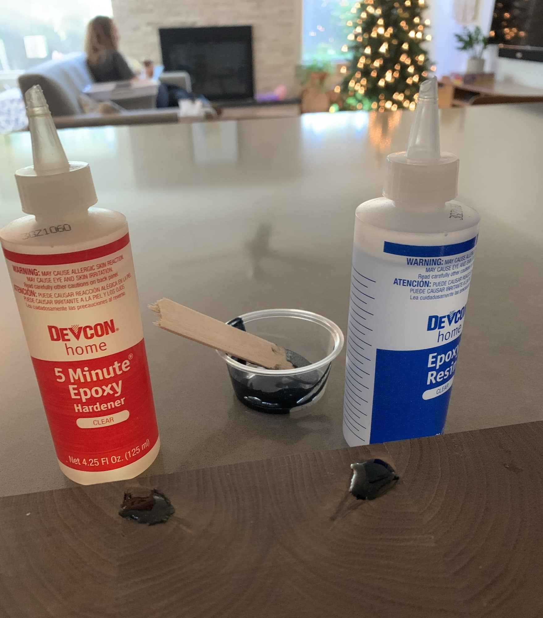 Picture showing black epoxy filling knots. A Christmas tree can be seen in the background.